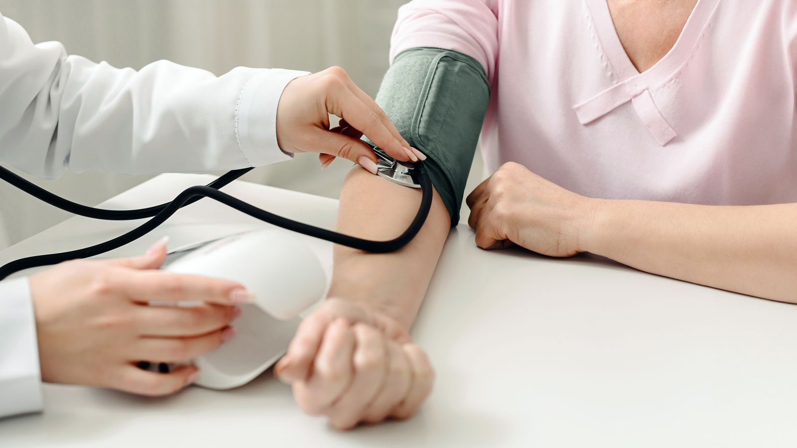Clinician checking a patient's blood pressure