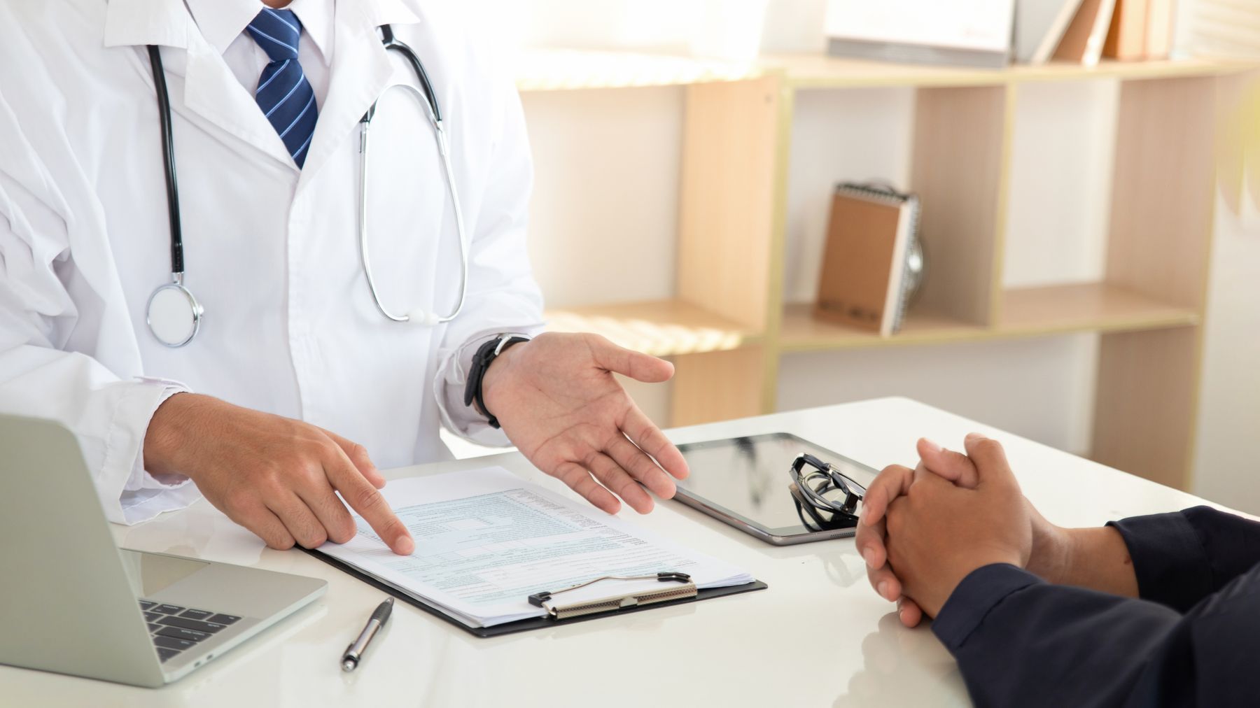 Physician reviewing health information with a patient during a consultation