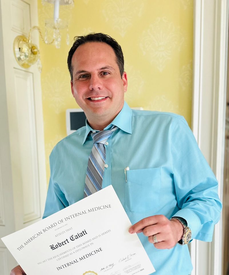 Dr. Robert Caiati holding his American Board of Internal Medicine certificate