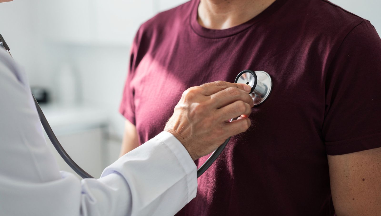 Physician listening to a patient's heart with a stethoscope