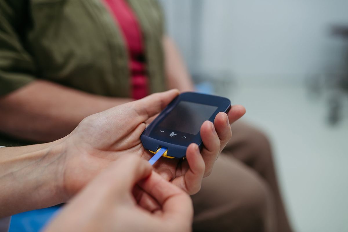 Patient checking blood sugar with a glucose meter